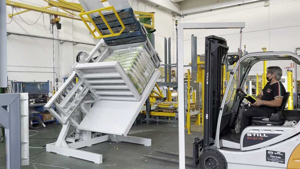 Pallet Flipper operating in a warehouse with stacked goods