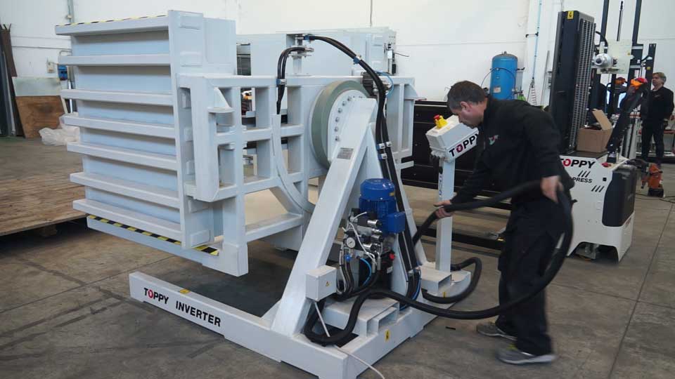 Technician performing routine maintenance on a Pallet Flipper machine