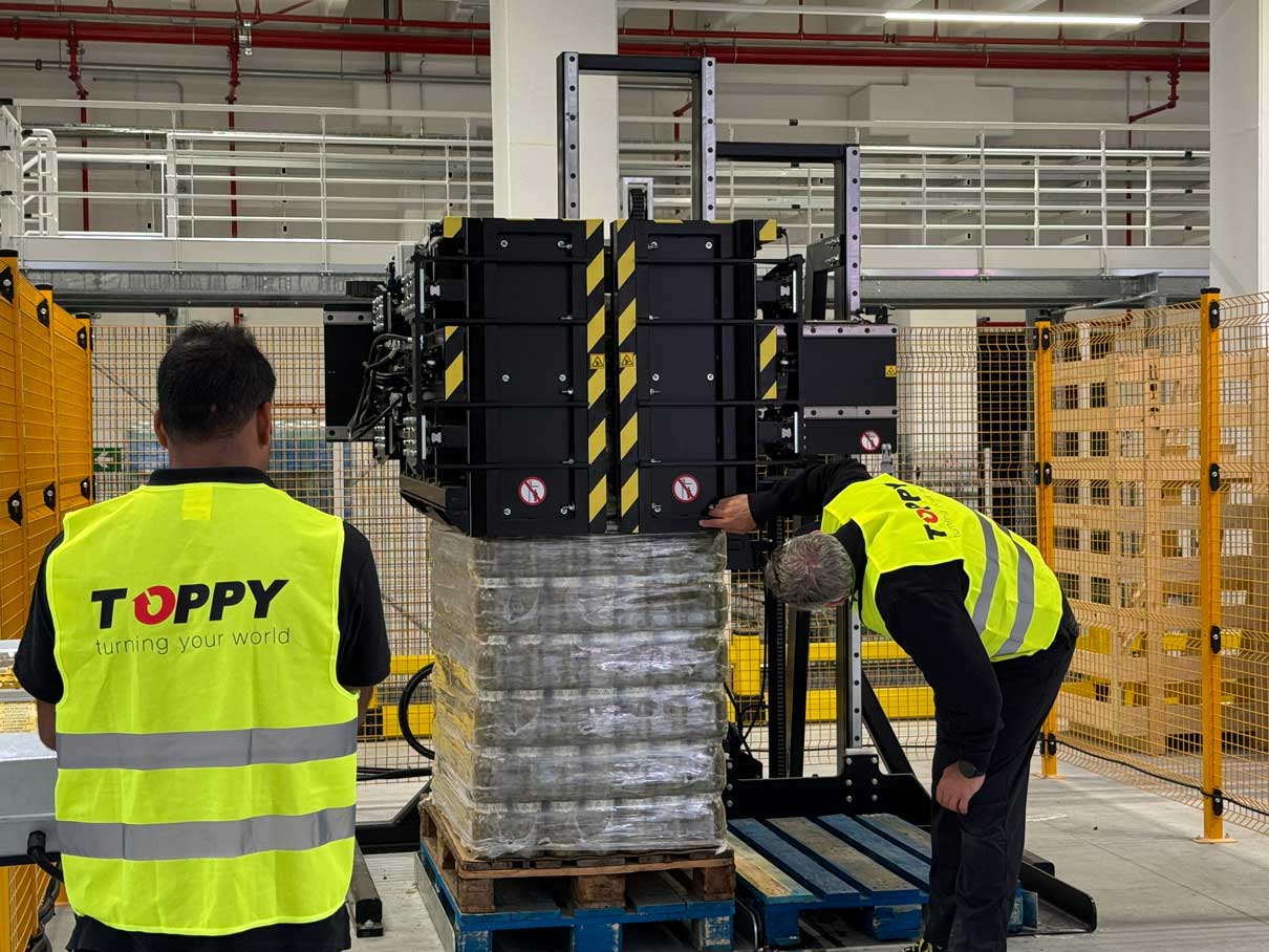 High-capacity layer picker and pallet inverter system in large-scale logistics operation
