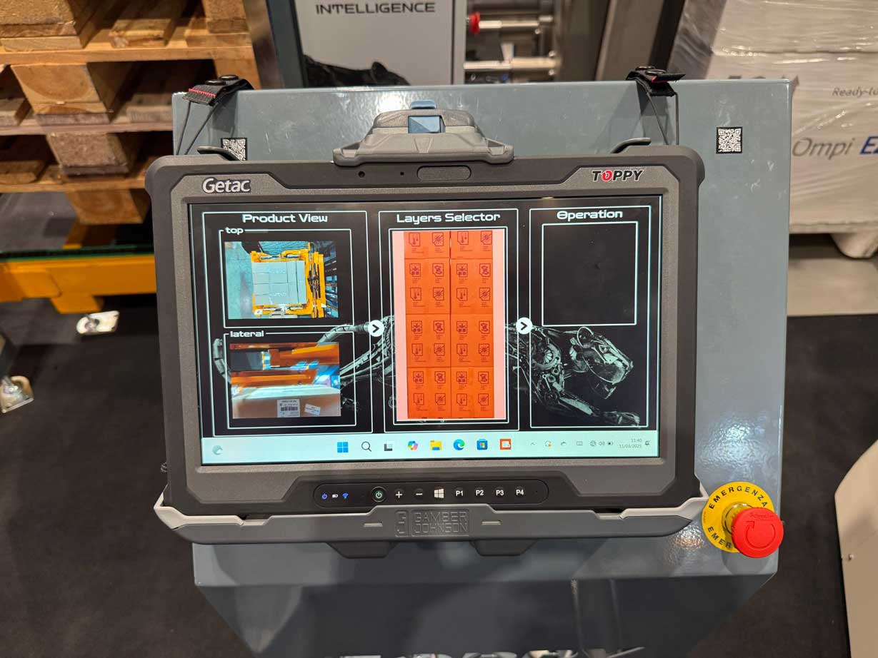 Operator controlling a pallet inverter and layer picker through a digital interface